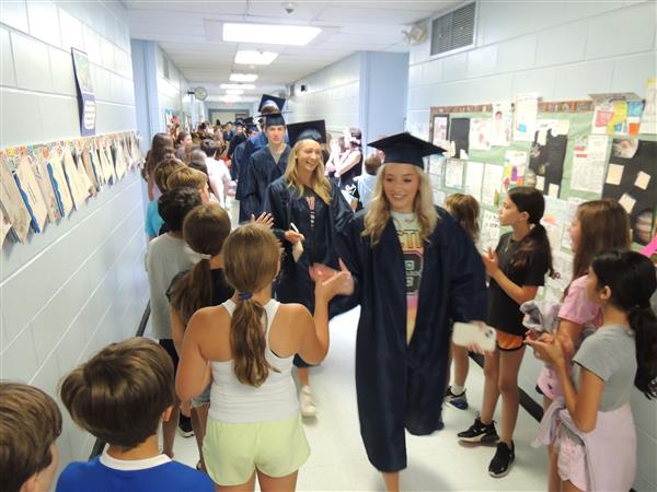  Graduates Walk the Hallways of Their Elementary Schools 